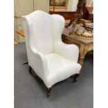 A Victorian upholstered wing armchair, on front cabriole legs, width 70cm, depth 75cm, height 114cm