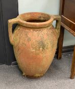 A pair of two handled terracotta amphoras, width 46cm, height 59cm