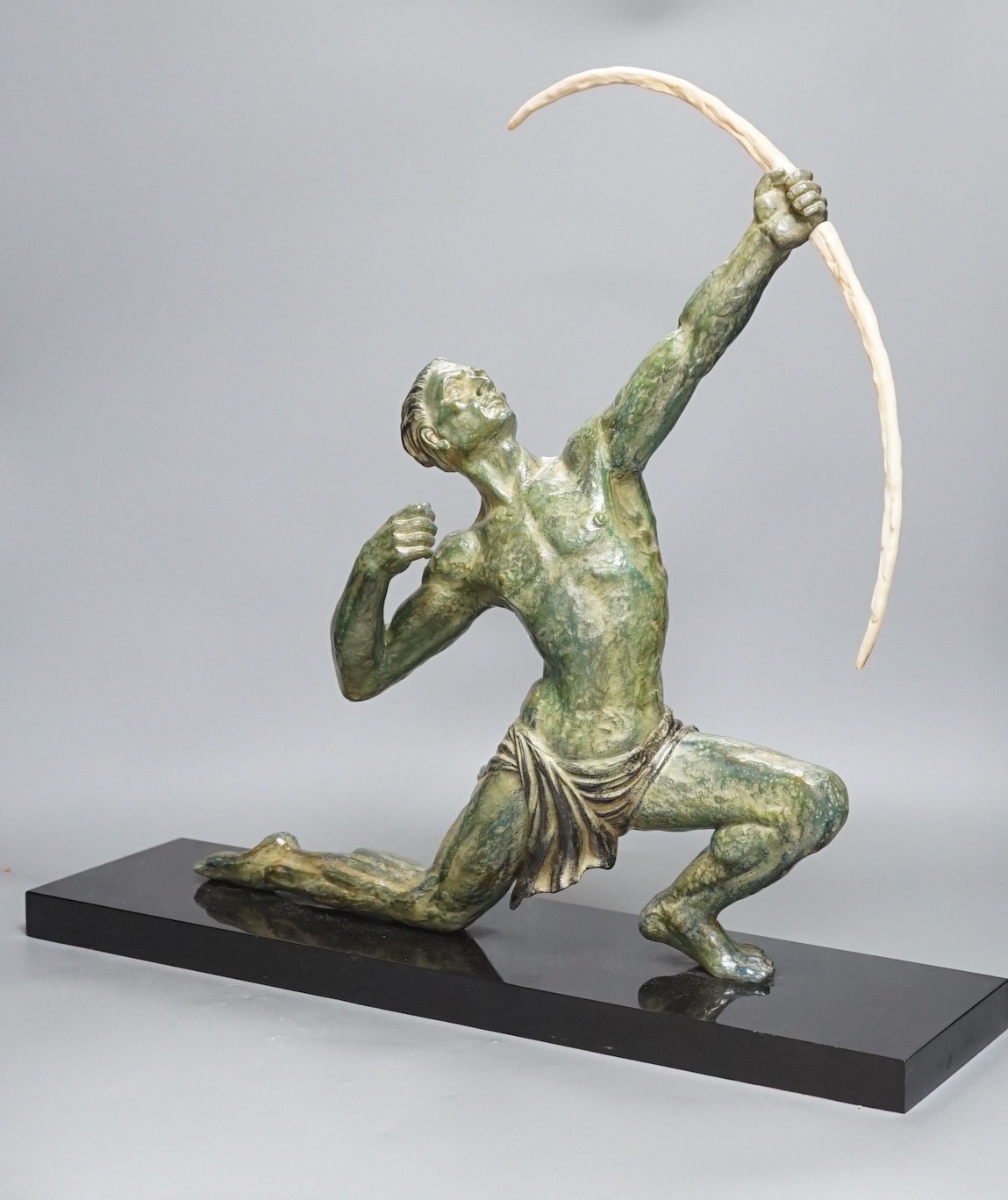 A large Art Deco bronzed figure of an archer, on black marble stand,55 cms wide,