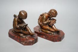 After Charles Gabriel Lemire (1741-1827), a pair of bronze studies of boys seated on cushions,