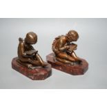 After Charles Gabriel Lemire (1741-1827), a pair of bronze studies of boys seated on cushions,