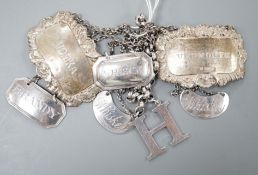 Seven assorted Georgian and later silver wine labels, including Scottish 'H', Robert Gray & Sons,