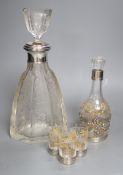 An early 20th century French white metal mounted gilded glass decanter and stopper and four matching