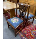 A pair of George III mahogany dining chairs with tapestry seats