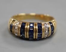 A modern yellow metal, sapphire chip and diamond chip set half hoop cluster ring, size M/N, ross