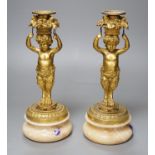 A pair of French gilt metal and onyx Bacchic faun candlesticks,25.5 cms high,
