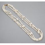 A modern 9k mounted triple strand cultured pearl necklace, 39cm, with yellow metal spacers.