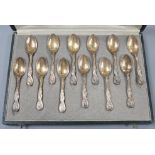 A cased set of twelve early 20th century French 950 standard white metal teaspoons, with foliate