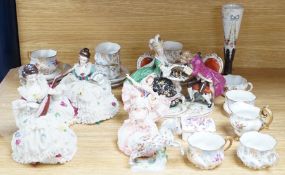 A group of Continental porcelain cabinet cups and saucers, a vase, crinoline figures and a Meissen
