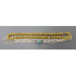 A multi-strand 'rice pearl' necklace with 18k white metal and turquoise set clasp, 66cm and an amber