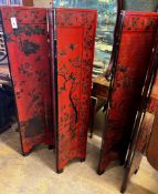 A pair of Chinese four fold lacquer screens decorated with exotic birds amongst branches, each panel
