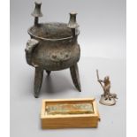 A Chinese green and russet jade belt buckle, an archaistic bronze tripod vessel and a figural