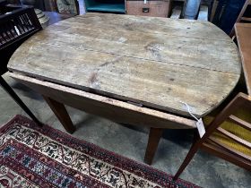 A 19th century French oak and pine circular drop leaf kitchen table, length 130cm, depth 90cm,