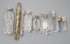 Nine assorted late 19th/early 20th century white or gilt white metal mounted glass scent bottles,
