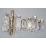 Nine assorted late 19th/early 20th century white or gilt white metal mounted glass scent bottles,