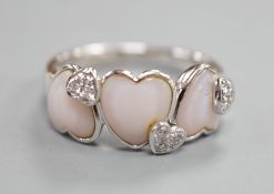 A modern 750 white metal three stone heart shaped mother of pearl? and diamond chip cluster set half