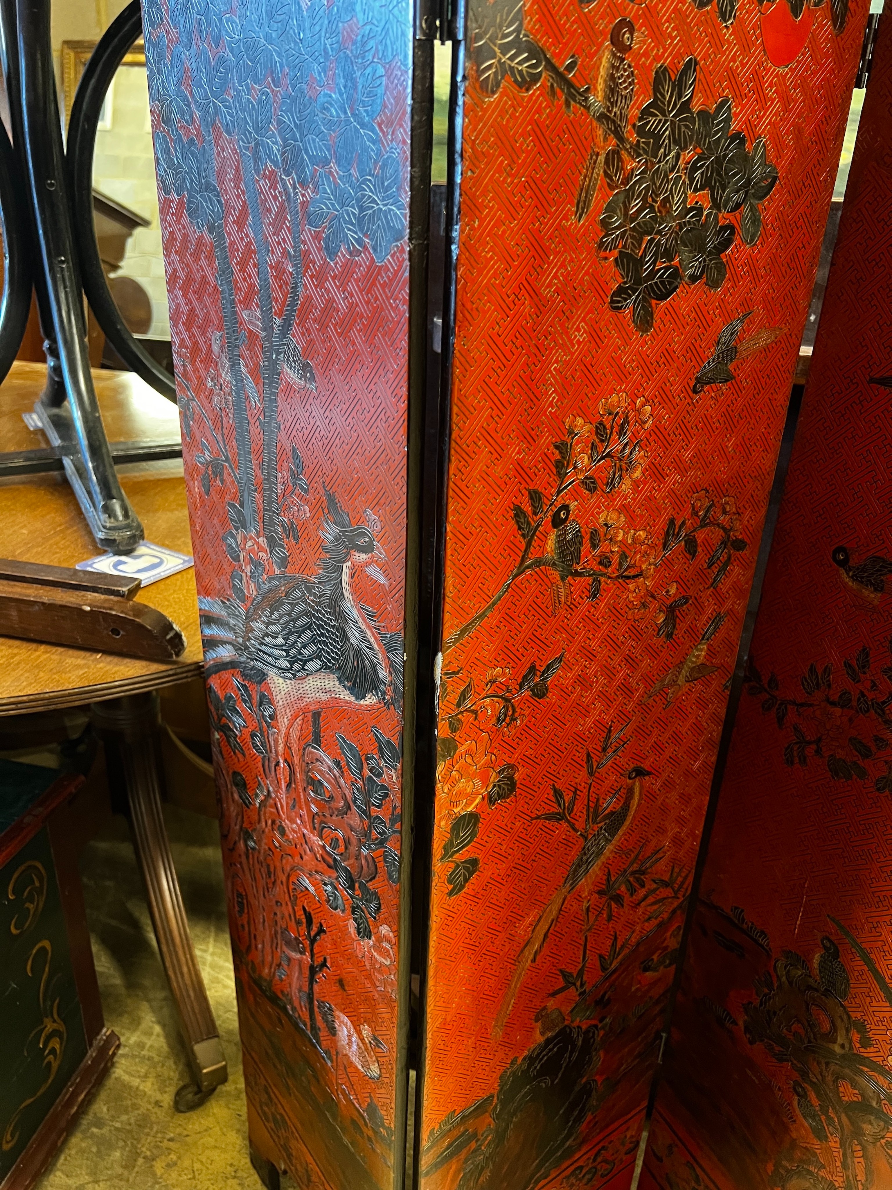 A pair of Chinese four fold lacquer screens decorated with exotic birds amongst branches, each panel - Image 4 of 4