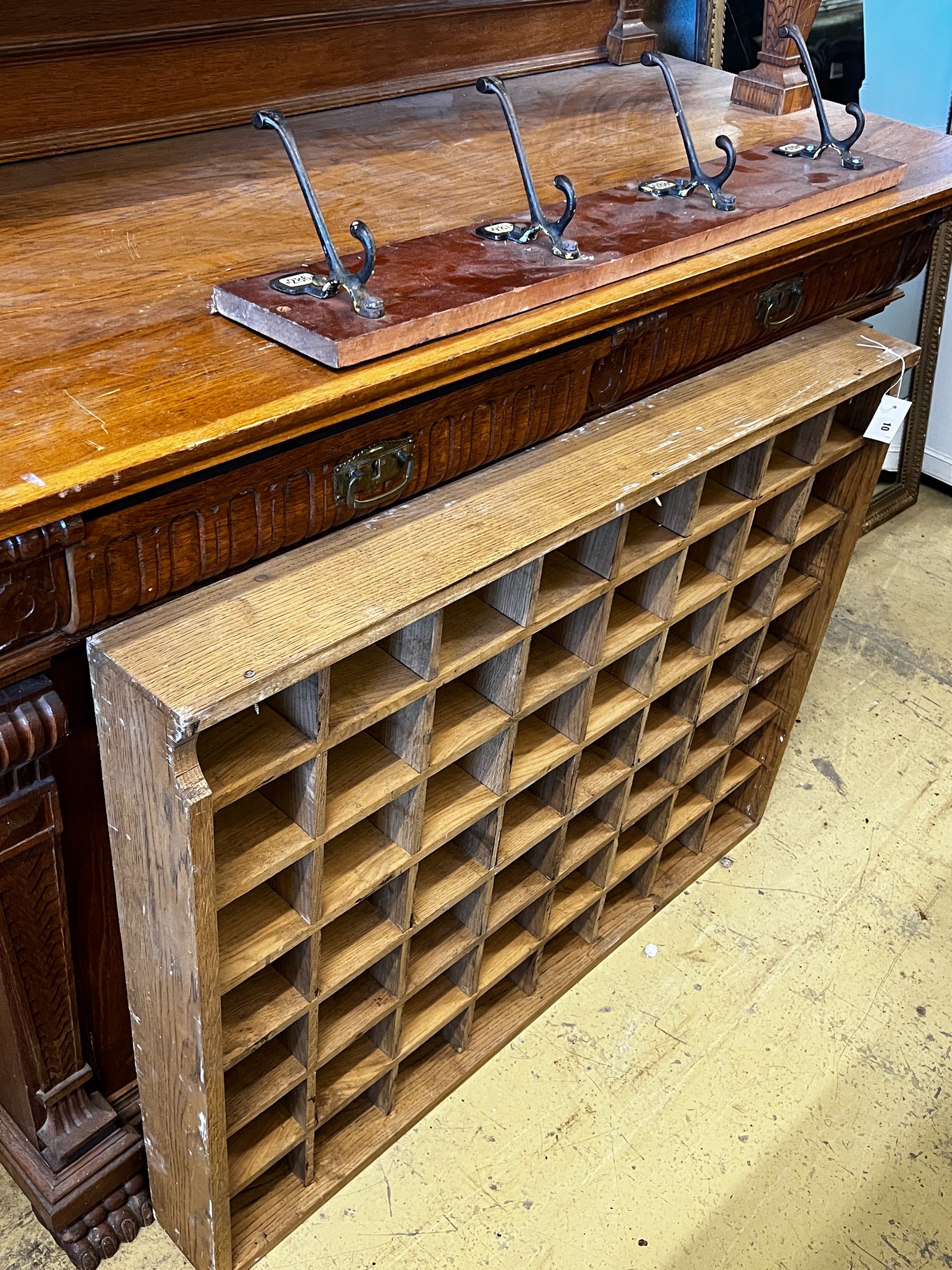 An oak pigeonhole unit, width 112cm, height 86cm together with a vintage four hook coat rack,