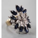 A modern 18k, sapphire and illusion set diamond chip set cluster dress ring, size K, gross weight