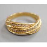 A modern 18ct gold and diamond chip set crossover ring, size N, gross weight 5.2 grams.