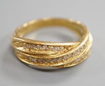 A modern 18ct gold and diamond chip set crossover ring, size N, gross weight 5.2 grams.