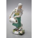 An 18th century Meissen figure of a girl pouring water from a jug on flowers at her feet, c.1755,
