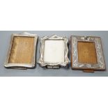 Three assorted early 20th century silver mounted photograph frames, including repousse,