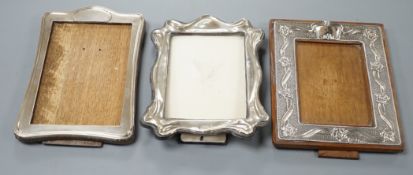 Three assorted early 20th century silver mounted photograph frames, including repousse,