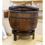 A Chinese wooden water bucket and carrying handle on stand,55cms including stand