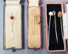 Three assorted early to mid 20th century yellow metal and gem set stick pins including diamond