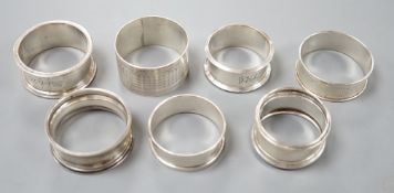 Seven assorted 20th century silver napkin rings, 121 grams.