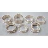 Seven assorted 20th century silver napkin rings, 121 grams.