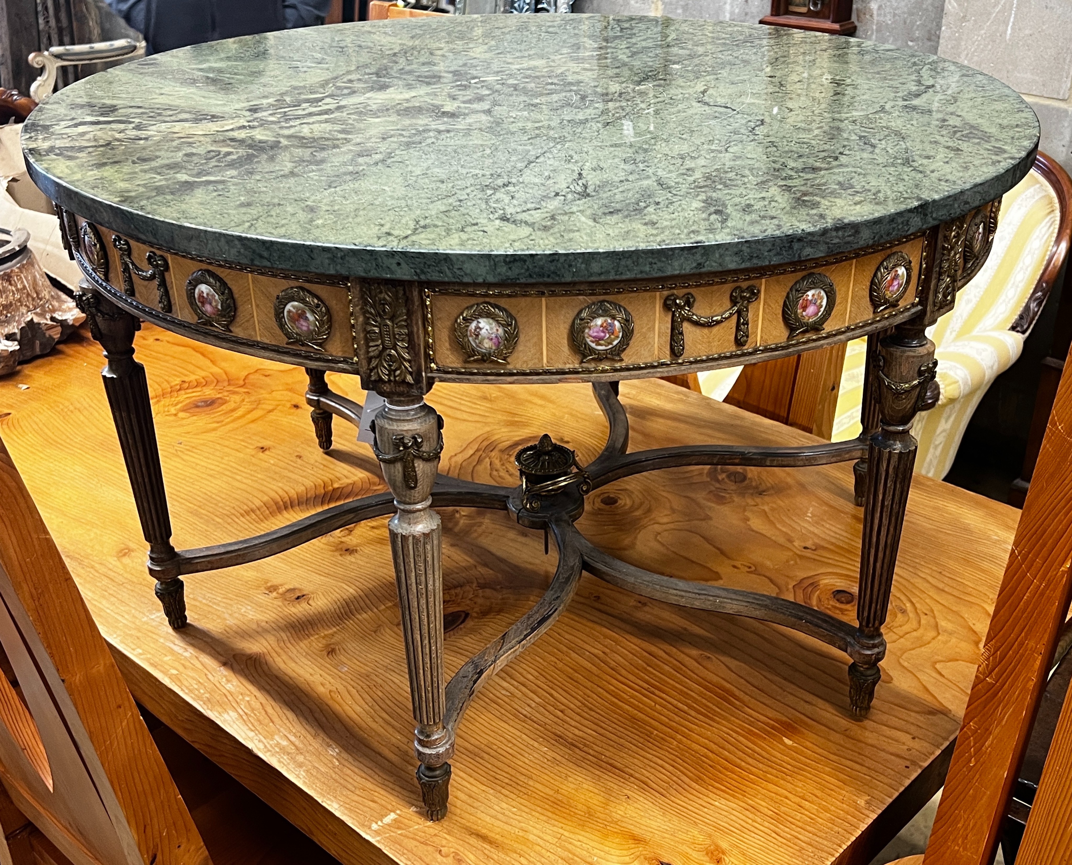 A Louis XVI design circular gilt metal and porcelain mounted marble top coffee table, diameter 84cm,