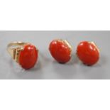 A 14k yellow metal and cabochon coral set oval ring, size N and a pair of matching earrings, lacking