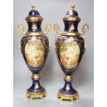 A pair of Sevres style urns and covers, with gilt metal mounts,50 cms high,