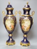 A pair of Sevres style urns and covers, with gilt metal mounts,50 cms high,