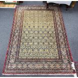 An antique North West Persian faded peach ground rug, 200 x 148cm