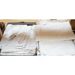 A quantity of French provincial linen sheets, some with monograms and button holed turn back,