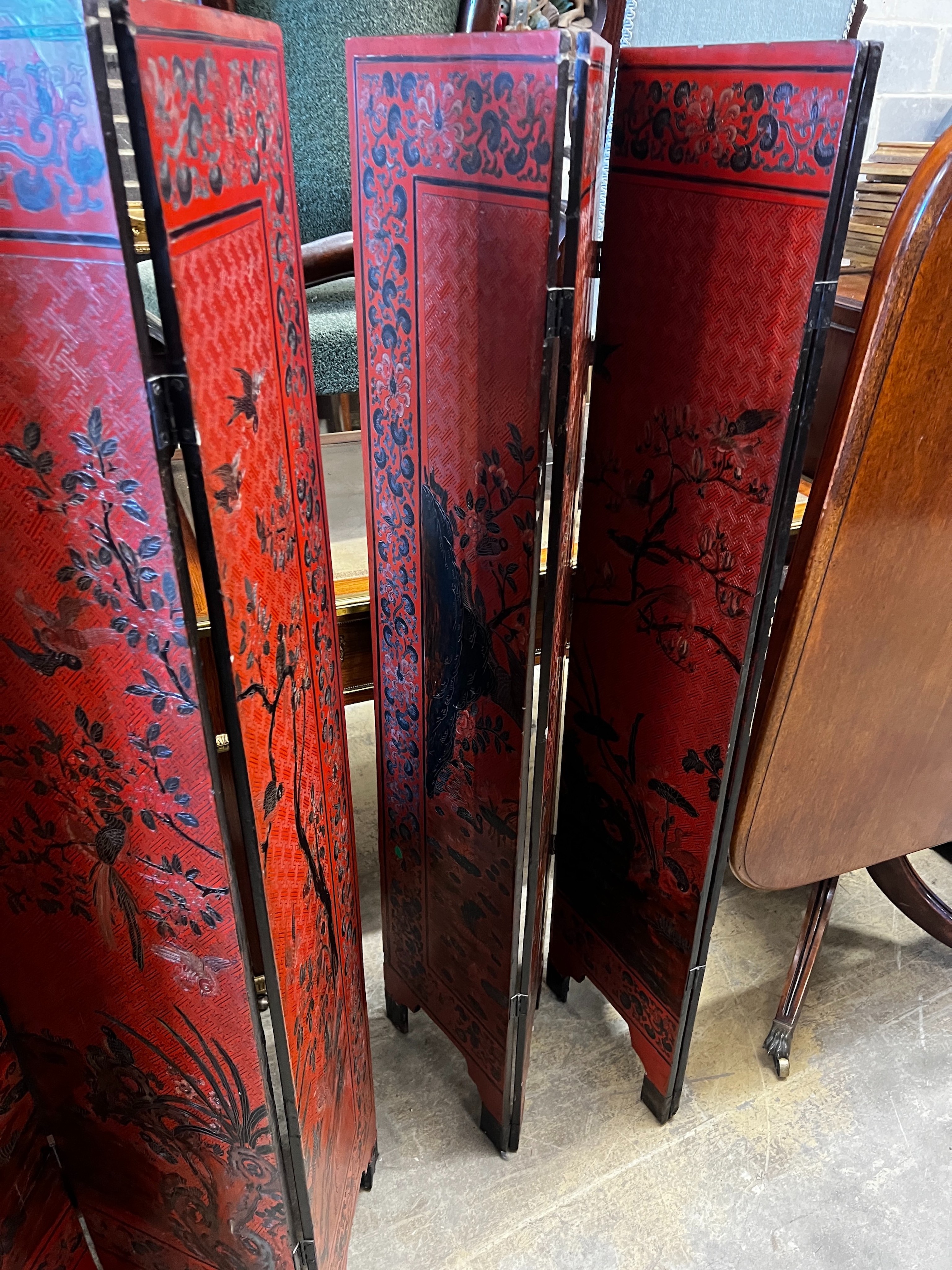 A pair of Chinese four fold lacquer screens decorated with exotic birds amongst branches, each panel - Image 2 of 4