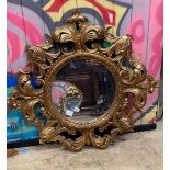 A circular wall mirror with carved giltwood frame, diameter 88cm