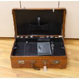 A Dupont travel suitcase, initialled ‘L.C.’ with French white metal mounted bottles