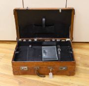 A Dupont travel suitcase, initialled ‘L.C.’ with French white metal mounted bottles