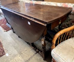 An early 18th century style oak oval topped gateleg dining table, (one leaf in need of repair),