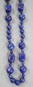 A single strand lapis lazuli round and barrel bead necklace, 72cm.