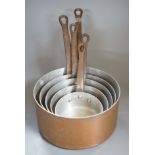 A graduated set of French copper saucepans