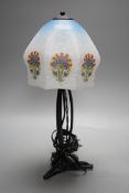 An Art Deco wrought iron table lamp on tripod base with frosted glass shade, 38cm tall