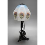 An Art Deco wrought iron table lamp on tripod base with frosted glass shade, 38cm tall