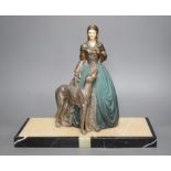 An Art Deco cold painted spelter and composition figure of a lady with a dog, signed R Miandres,