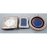 A modern silver mounted desk timepiece, 15.2cm and two mounted photograph frames, including