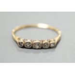 A yellow metal and graduated collet set five stone diamond half hoop ring, size O, gross weight 1.